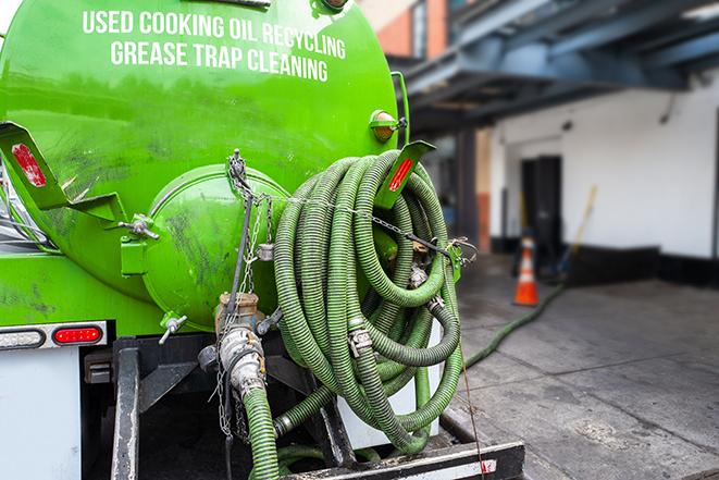 a vacuum truck pumping out a large underground grease trap in College Place, WA